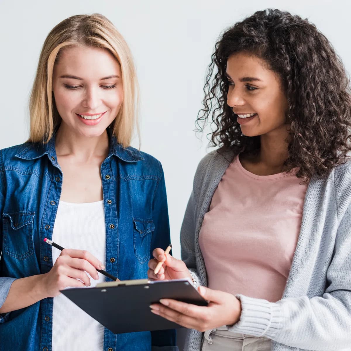 employees-discussing-writings-clipboard